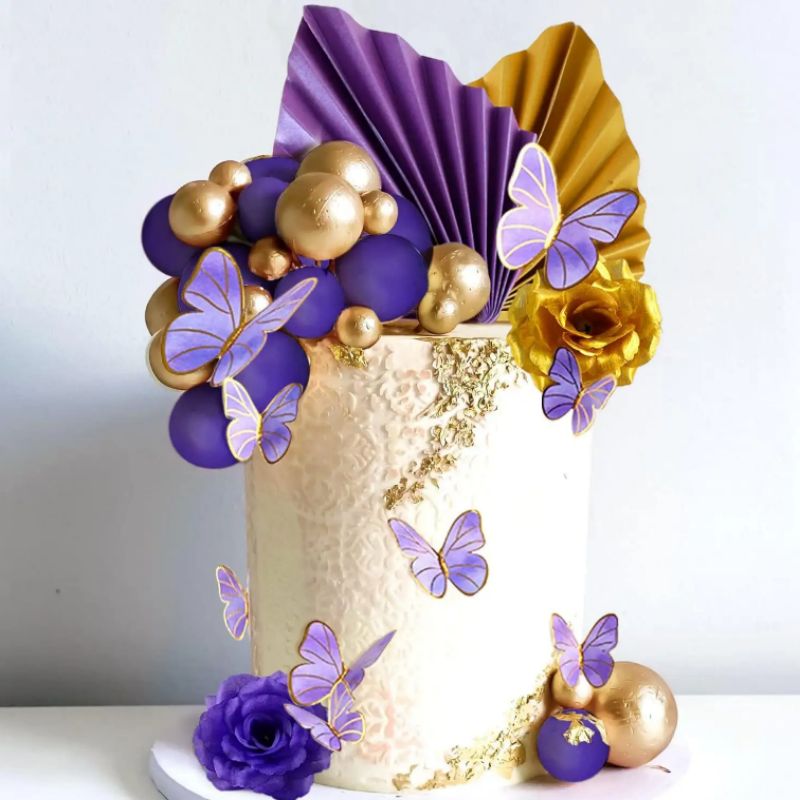 Bohemian themed cake decoration birthday featuring paper folding fans and butterfly cake toppers for birthday